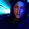 24 pixelated faces with varying expressions against a blue geometric background, each face showing different mouth positions and head angles