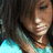 A pixelated close-up of a person with dark hair wearing a light blue top, showing partial facial features and clothing details.