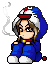 Pixel art character in blue hooded outfit with white trim and red accent, seated with crossed legs, brown hair visible under hood, small red object at feet, gray background.