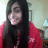 A static pixelated image shows a person with long dark hair wearing a red garment, positioned against a light-colored background with indistinct shapes.