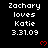 Black background displays repeated white text 'Zachary loves Katie 3.31.09' with red heart symbols, partially cropped at bottom right.