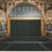 Pixelated static image of a theater facade with arched entrance, columns, and dark interior space.