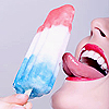 A close-up of a person's mouth with red lips and a tongue extended toward a red-white-blue striped popsicle held by a hand.
