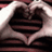 Two hands form a heart shape with dark interior; purple text 'love' appears in the right frame.
