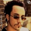 six identical images showing a person with dark hair, sunglasses, and a mustache against a brick wall background