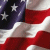 A 50x50 pixel animated buddy icon featuring a split composition with an American flag on the left and a person in formal attire on the right, displayed as two sampled frames from an animation.