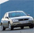 Pixelated static image of a silver sedan with dark windows and black tires against a blue background.