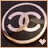 Circular icon with stylized interlocking letters inside a glowing ring, featuring a small heart symbol at the bottom right.