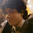 A pixelated image of a person with dark hair holding a microphone, accompanied by red text reading 'emily', 'loves', and 'nick jonas' on a black background.