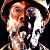 Pixelated image of two figures in a close embrace, one with light brown hair and the other with dark hair, against a black background.