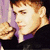 A pixelated image of a person with light brown hair and fair skin holding a flower, next to blue text on purple background reading "greece loves BIEBS".