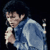 Pixelated static image of a person in blue clothing holding an object against dark background with visible dithering and compression artifacts.