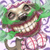 Pixelated cartoon character with green hair, red lips, and a wide grin showing teeth, wearing a red collar and brown pants against a purple and green background.