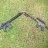 A static pixelated image of a rifle with blue and gray tones against a greenish background.
