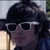 A person with dark hair and white sunglasses appears in four showing slight head movement against a blurred background