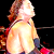A pixelated image of a person with long brown hair in a yellow top, shown from two angles against a dark background with red accents, next to a blue section with 'CoolBuddy.com' text.