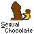 Pixelated brown figure with yellow lower body holding a small round object, set against gray background with 'Sexual Chocolate' text below.