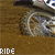 Animated sequence showing a dirt bike wheel in motion on brown terrain with text changing from 'RIDE' to 'HARD'.