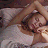 A static image featuring a person lying in bed with text overlay reading "without you, I don't sleep..." and "I just dream" on a gray background.