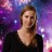 Pixelated static image of a person with light brown hair wearing a dark top against a purple and blue gradient background with scattered white dots.