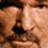 Three pixelated close-up images of a man's face arranged horizontally above bold white text on dark background, with partial text below.