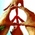 Four hands form peace sign, heart shape, and star shape against sky and green background.