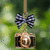 A pixelated camera icon with a checkered bow hangs from a string against a blurred green background, with green text appearing below it.