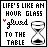 16 identical pixel art icons featuring the text 'LIFE'S LIKE AN HOUR GLASS glued TO THE TABLE' with a sandglass symbol, each icon's word 'glued' marked by a distinct colored dot