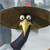 Pixelated cartoon bird with large brown hat, yellow beak, black neck, and wide eyes against blurred background.