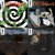 A pixelated static image shows a green and white spiral pattern on the left, with a blurred abstract shape on the right, all on a dark background with faint horizontal color bands.