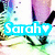 A pixelated image shows a person's legs in white shoes and purple socks with a green and blue patterned background. The name "Sarah" with a heart symbol appears in different colored text overlays.