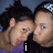 Two people with dark curly hair and silver headbands pose closely together in a pixelated image, one person's mouth is open while the other has lips closed.