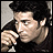 A 48x48 pixel animated contact sheet showing two frames of a man with dark hair in a black shirt, one frame close-up and the other wider shot with text above him.