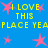 Blue background with yellow text reading "I LOVE THIS PLACE YEA" and pink star shapes scattered throughout.