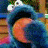A pixelated contact sheet showing two frames of an animated Sesame Street character icon with green text branding on the right side.