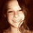 Pixelated image of a smiling person with long brown hair on the left, next to four text blocks in white pixel font on black background.
