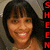 Pixelated portrait of a person with dark hair and bangs, smiling broadly against a muted background with red vertical text on the right.