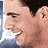 Red background with orange stars and repeated 'CHASING CHASING LIBERTY' text, featuring a person's face in star-shaped cutouts.
