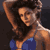 Pixelated static image of a person in swimwear with dark hair and blue bottoms, viewed from the side against a dark background.