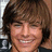 Pixelated image of a smiling person with brown hair, green text reading 'zac efron', 'makes me', and 'barf!!! ewwww!' on black background