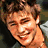 A 4-frame contact sheet of a young man with light brown hair in various expressions and poses, including smiling, neutral, and open-mouthed looks, alongside a black background frame with white text reading "Coolbuddy.com".