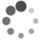 A grayscale animation of scattered circular dots in varying shades of gray, with a solid gray rectangle in the bottom-right corner.