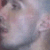 Pixelated image of a person's face with soft pastel colors and indistinct features, lacking clear facial details or text.
