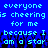 Pixelated blue background with cyan text repeating 'everyone is cheering for me because I am a star' and black silhouettes of raised hands below.