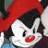 Two side-by-side animated frames of a cartoon character with black ears, white face, red nose, and red hat against orange background.