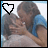 Two side-by-side animated frames showing a couple embracing, with heart icons changing from black to blue outline between frames.