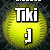 Yellow softball with visible stitching, overlaid text "Tiki" and "Miki" in bold white font with black outlines, small white dot below each text block.