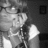 Black-and-white animated icon shows a person with glasses and a white sleeveless top, with subtle facial expression changes across frames.
