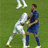 Two pixelated figures in athletic wear on a green field, one in white and one in blue, engaged in physical contact.