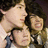 Three pixelated faces in close proximity, two with dark hair and one with lighter hair, all facing slightly left with neutral expressions.